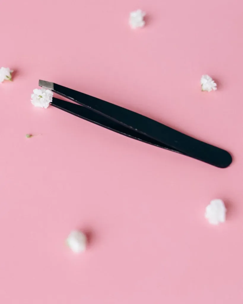 Pinza de aislamiento recta negra sobre fondo rosa